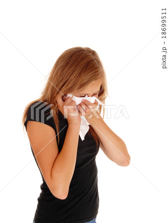 Little girl blowing her nose. 18699511