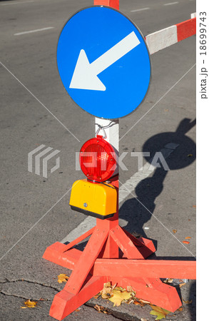 Roadsign with red light and white arrow in circle 18699743