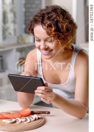 Content loving couple having fun in the kitchen  18702369