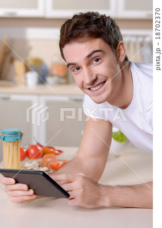 Content loving couple having fun in the kitchen Content loving couple having fun in the kitchen 18702370