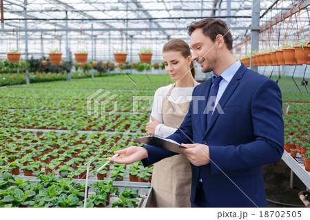 Positive businessman discussing business with his 18702505
