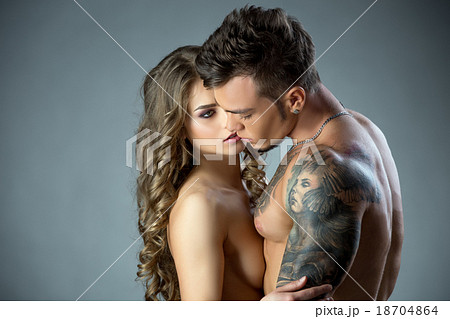 Charming model lovingly looks at tattooed man 18704864