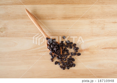 Coffee Beans on the wooden table Coffee Beans on the wooden table 18710948