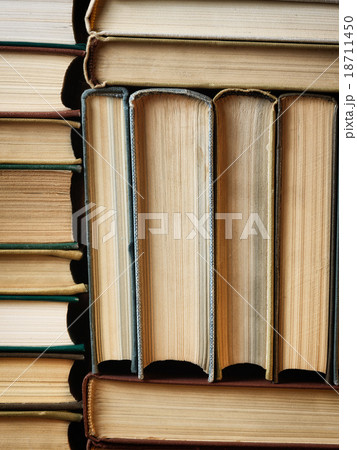 Background made of old books arranged in stacks Background made of old books arranged in stacks 18711450