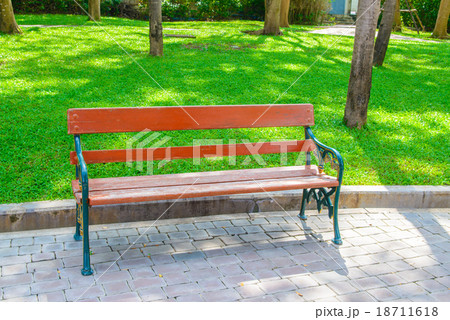 Green and brown wooden park bench 18711618