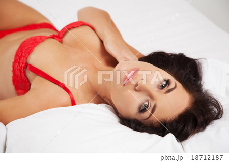 Young beautiful woman in her bed 18712187