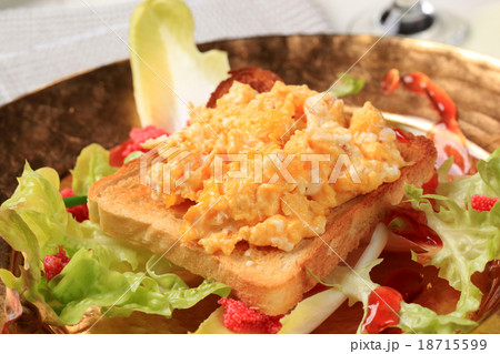 Scrambled eggs on toast and fresh salad 18715599