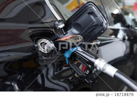 Pumping gasoline fuel in the car at gas station 18718876