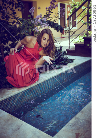 beautiful young lady posing near small pool 18720961