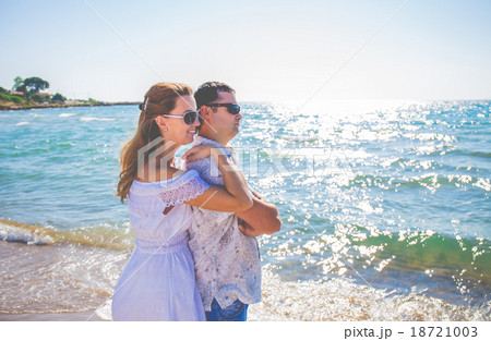 enamored couple posing on a beach 18721003