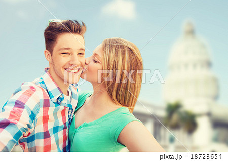 couple kissing and taking selfie over white house couple kissing and taking selfie over white house 18723654