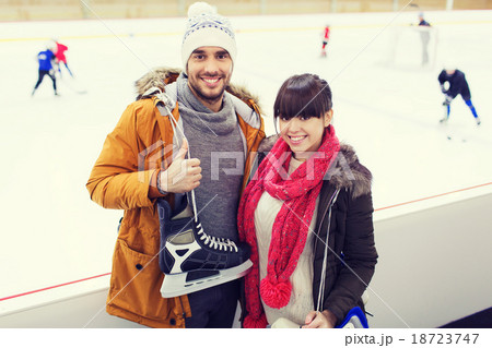 happy couple with ice-skates on skating rink happy couple with ice-skates on skating rink 18723747