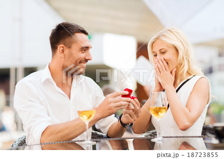 happy couple with engagement ring and wine at cafe happy couple with engagement ring and wine at cafe 18723855