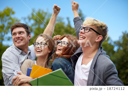 group of happy students showing triumph gesture 18724112