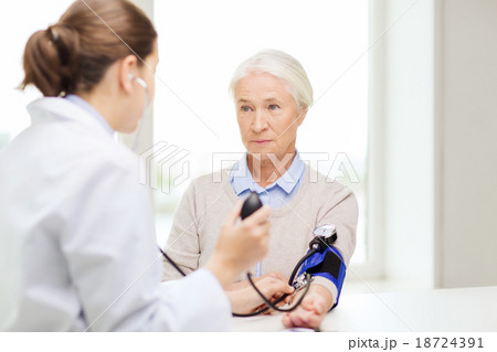 doctor with tonometer and senior woman at hospital 18724391