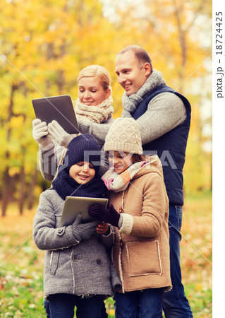happy family with tablet pc in autumn park 18724425