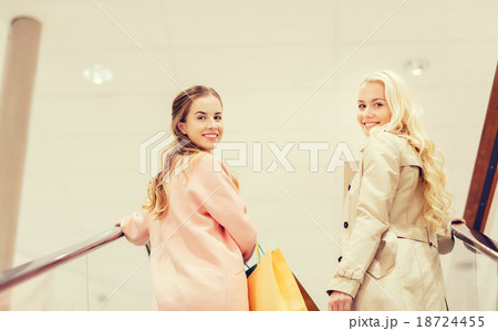 happy young women with shopping bags in mall 18724455
