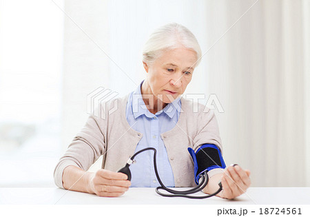 old woman with tonometer checking blood pressure old woman with tonometer checking blood pressure 18724561