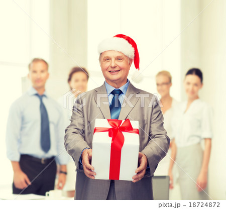 smiling man in suit and santa helper hat with gift smiling man in suit and santa helper hat with gift 18724872