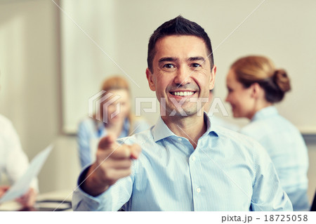 group of smiling businesspeople meeting in office 18725058