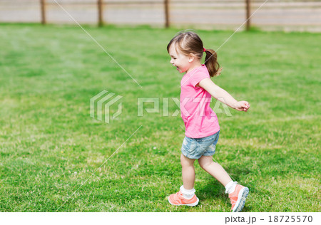 happy little girl running on green summer field happy little girl running on green summer field 18725570