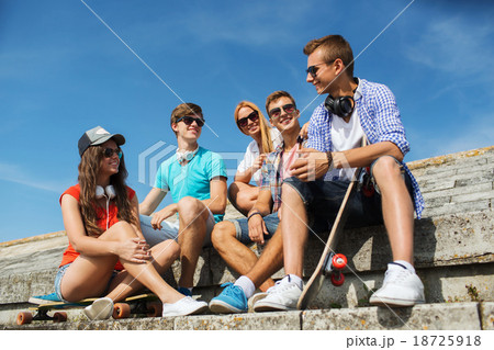 happy teenage friends with longboard on street happy teenage friends with longboard on street 18725918