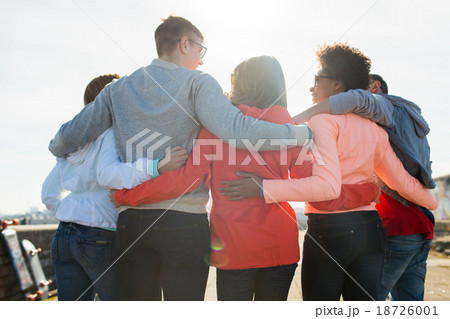 group of happy teenage friends hugging on street group of happy teenage friends hugging on street 18726001