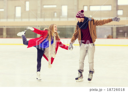 happy couple holding hands on skating rink happy couple holding hands on skating rink 18726018