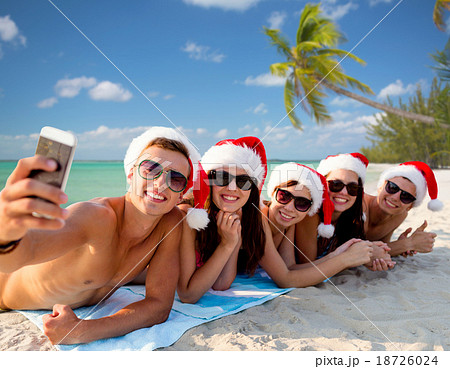 group of friends in santa hats with smartphone group of friends in santa hats with smartphone 18726024