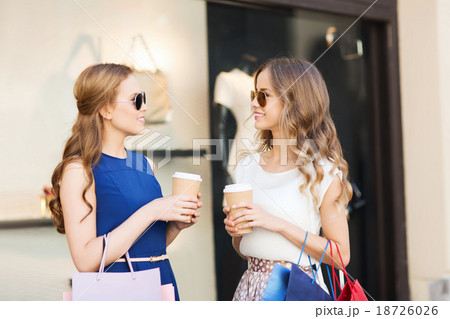 young women with shopping bags and coffee at shop young women with shopping bags and coffee at shop 18726026