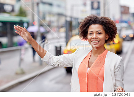happy african woman catching taxi happy african woman catching taxi 18726045