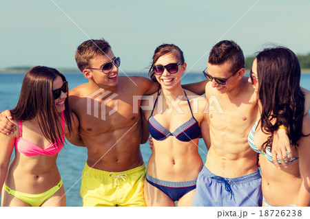 smiling friends in sunglasses on summer beach 18726238