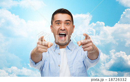 scared man shouting and pointing finger on you 18726332