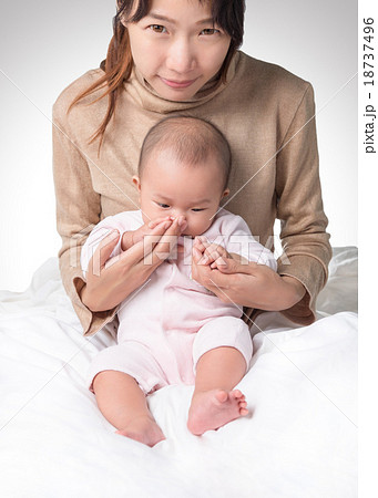 young asian mother and baby in white bed isolated 18737496