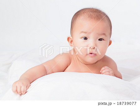 lovely Asian baby lying on stomach. looking 18739077