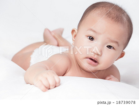 cute Asian baby lying on stomach. looking 18739078