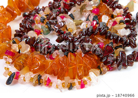 beads of different stones on a white background 18740966