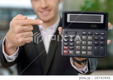 Male salesperson is showing the price deal. Male salesperson is showing the price deal. 18742949