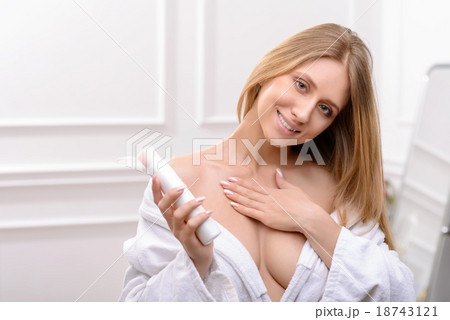 Pleasant woman using cream for body Pleasant woman using cream for body 18743121