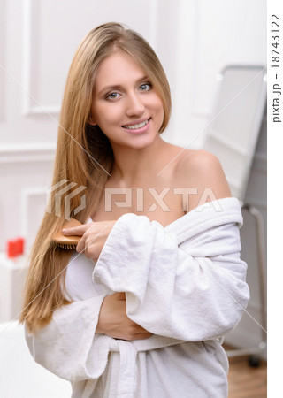 Beautiful girl brushing her hair Beautiful girl brushing her hair 18743122