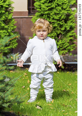 Cute infant on green grass Cute infant on green grass 18754049