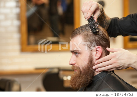 Attractive young bearded hipster attending the Attractive young bearded hipster attending the 18754752