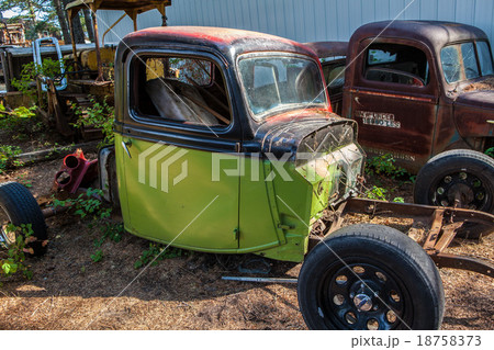 Old rusted car in junk yard 18758373