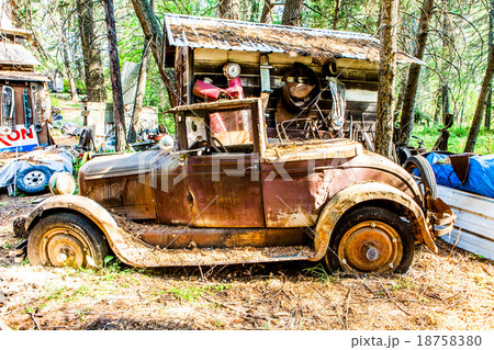 Old rusted car in junk yard 18758380
