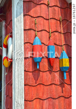 Colorful fishing buoys hanging on the wall 18761297