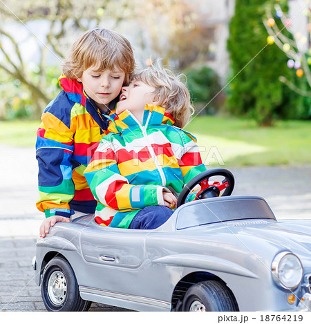 Two happy sibling boys playing with big old toy 18764219