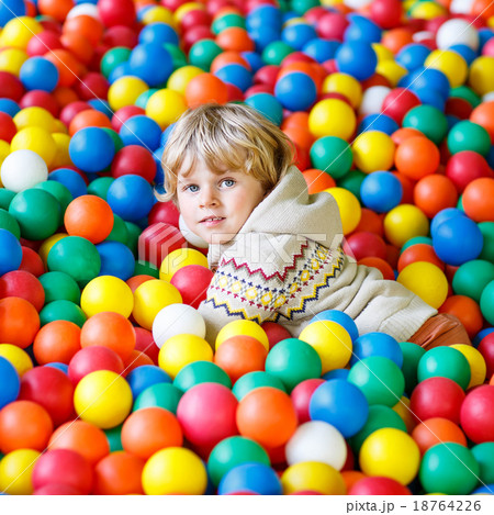 child playing at colorful plastic balls playground 18764226