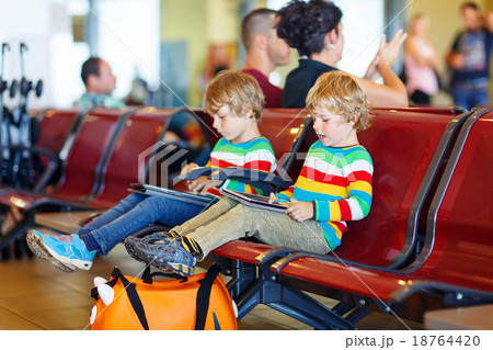 Two tired little sibling boys at the airport Two tired little sibling boys at the airport 18764420