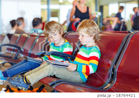 Two tired little sibling boys at the airport Two tired little sibling boys at the airport 18764421