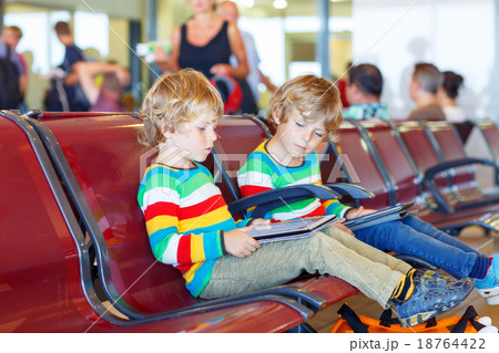 Two tired little sibling boys at the airport Two tired little sibling boys at the airport 18764422